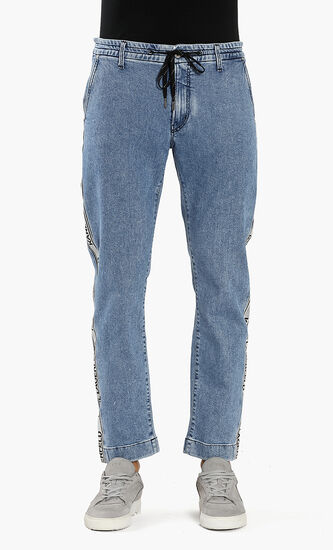 بنطال جينز بشريط مزين بشعار