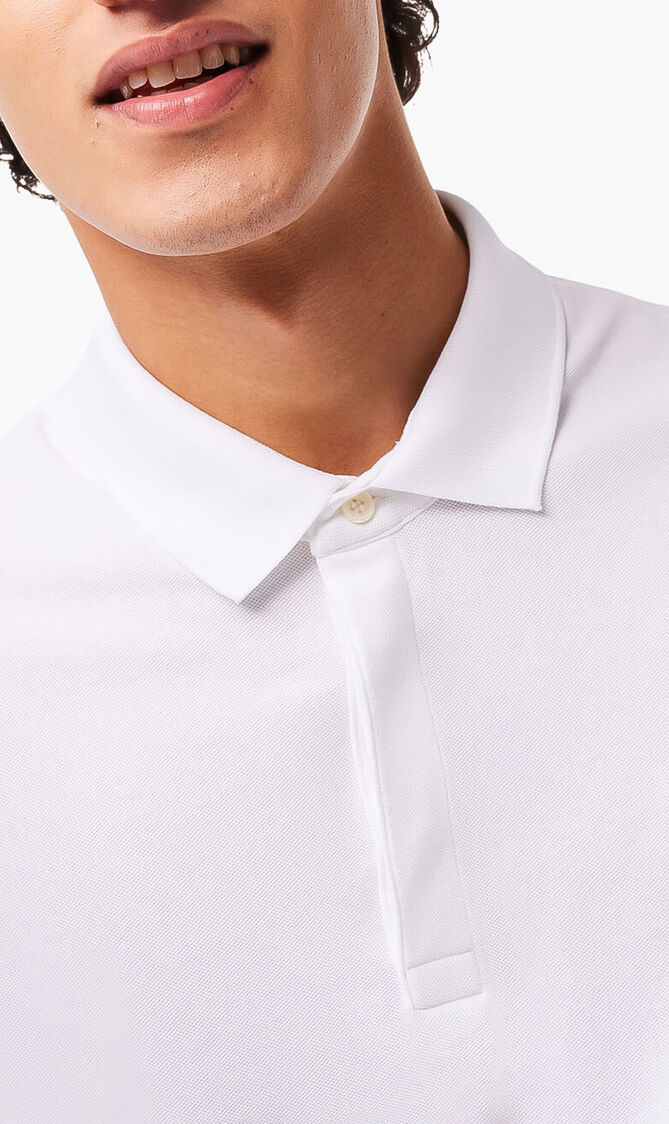 قميص بولو من نسيج مرن ذو قصة كلاسيكية وأكمام طويلة قميص بولو من نسيج مرن ذو قصة كلاسيكية وأكمام طويلة