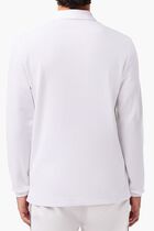 قميص بولو من نسيج مرن ذو قصة كلاسيكية وأكمام طويلة قميص بولو من نسيج مرن ذو قصة كلاسيكية وأكمام طويلة